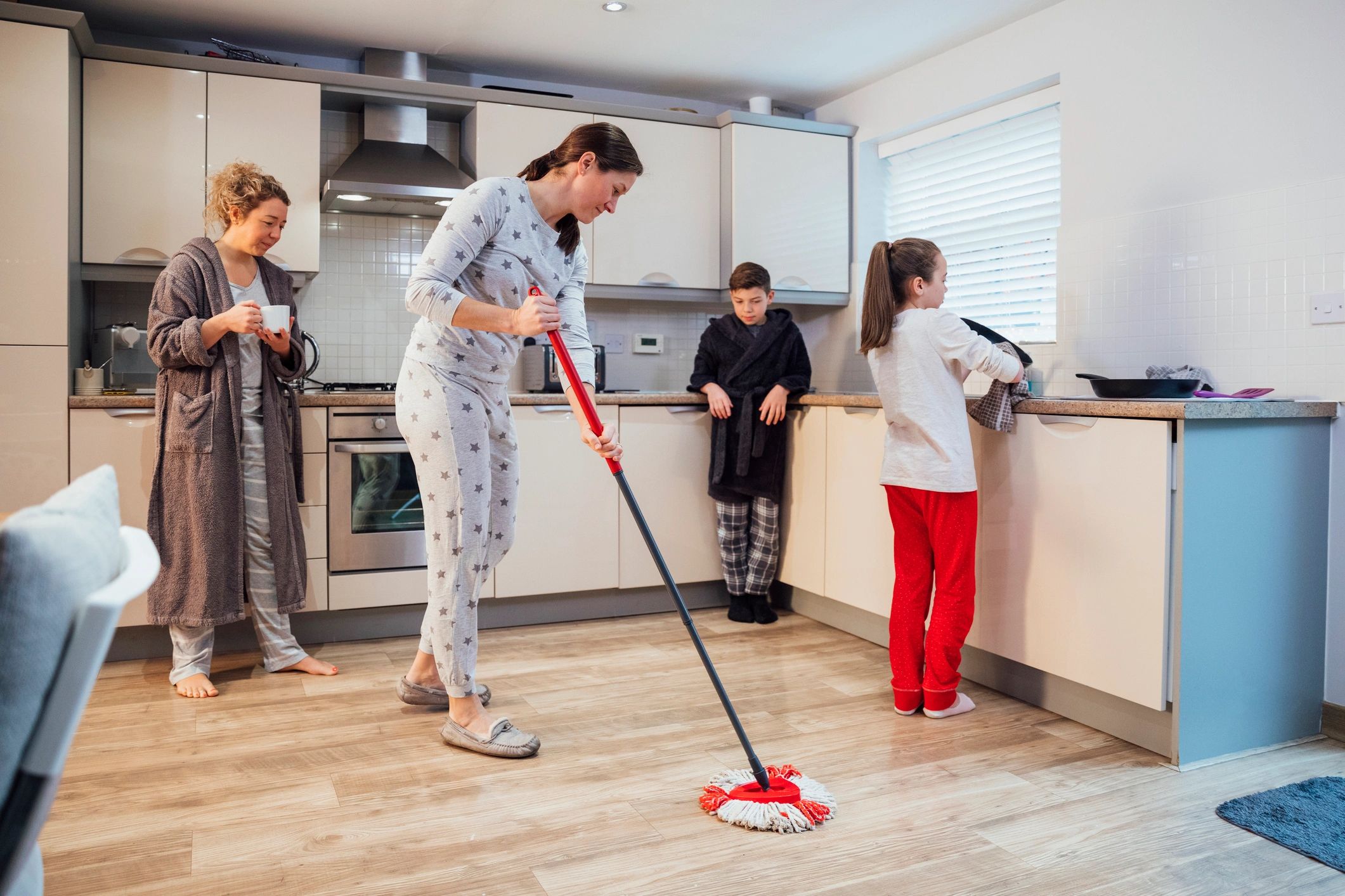 Family cleaning a kitchen together