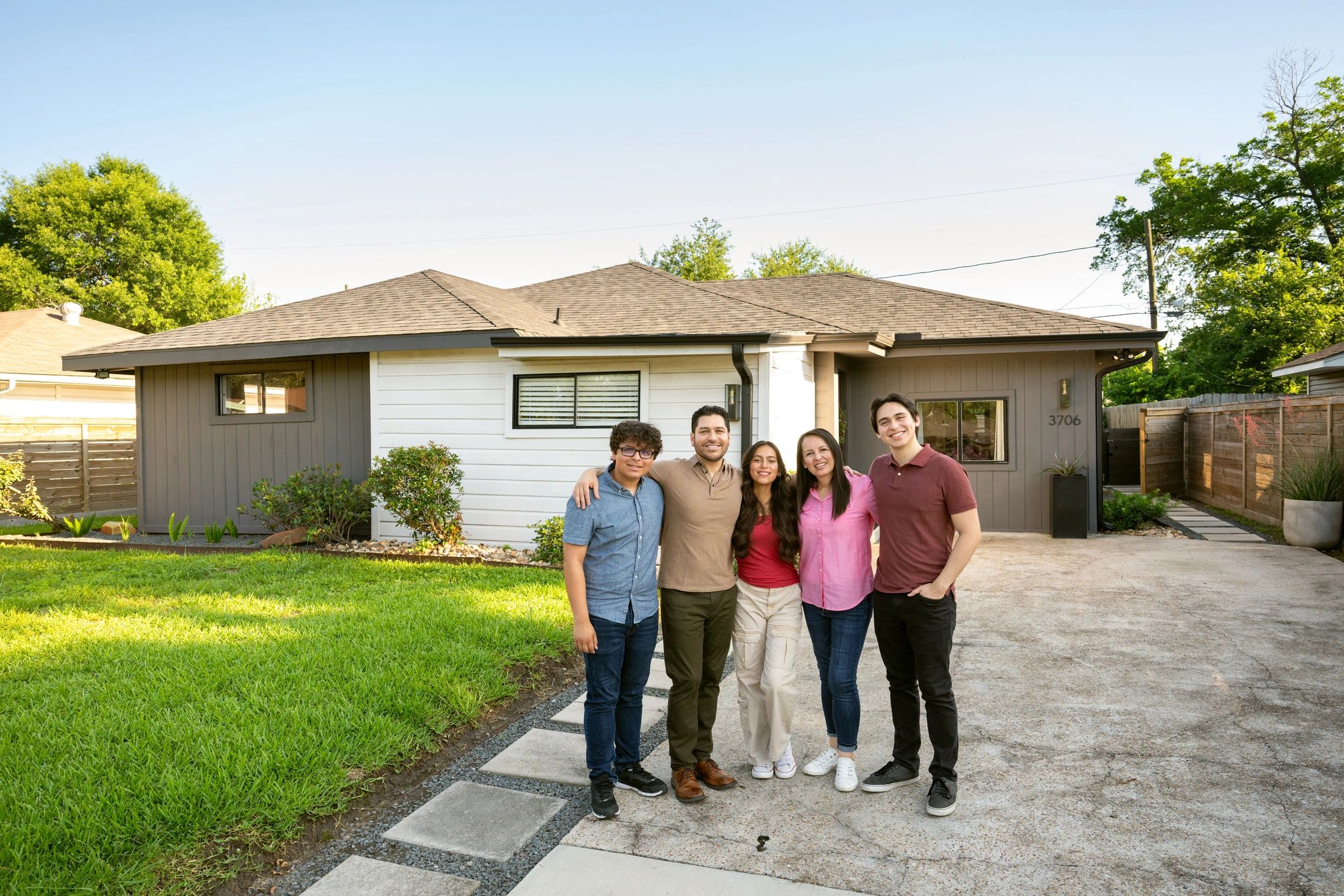 Homeowners outside a comfortable, well-maintained home
